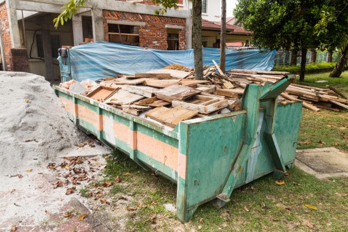 Business professionals managing waste in a modern office setting in North West London